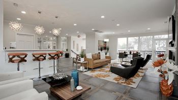 A modern living room with a black chair and a wooden coffee table.